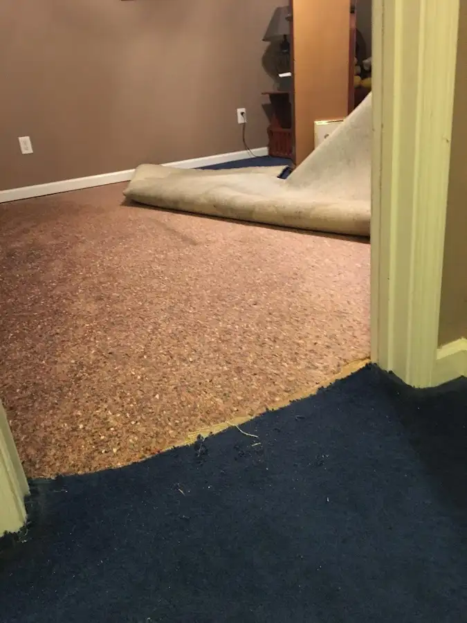 Carpet pad removal revealing water damage during Water Mitigation Services in San Luis Obispo