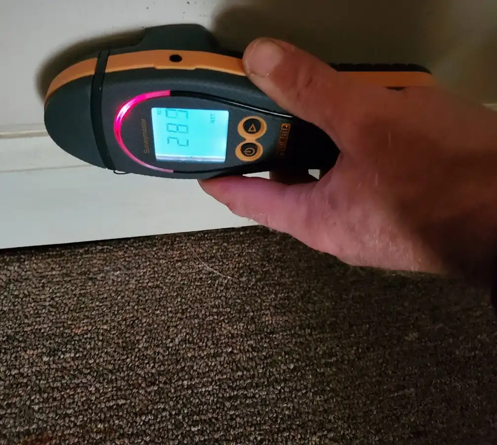 Moisture detection at baseboard during Storm Damage Restoration in San Luis Obispo